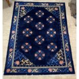 A Chinese super washed wool carpet, the blue ground decorated with repeating medallions and having a