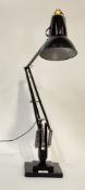 Herbert Terry and Sons, a mid century anglepoise lamp, finished in black paint, on a stepped