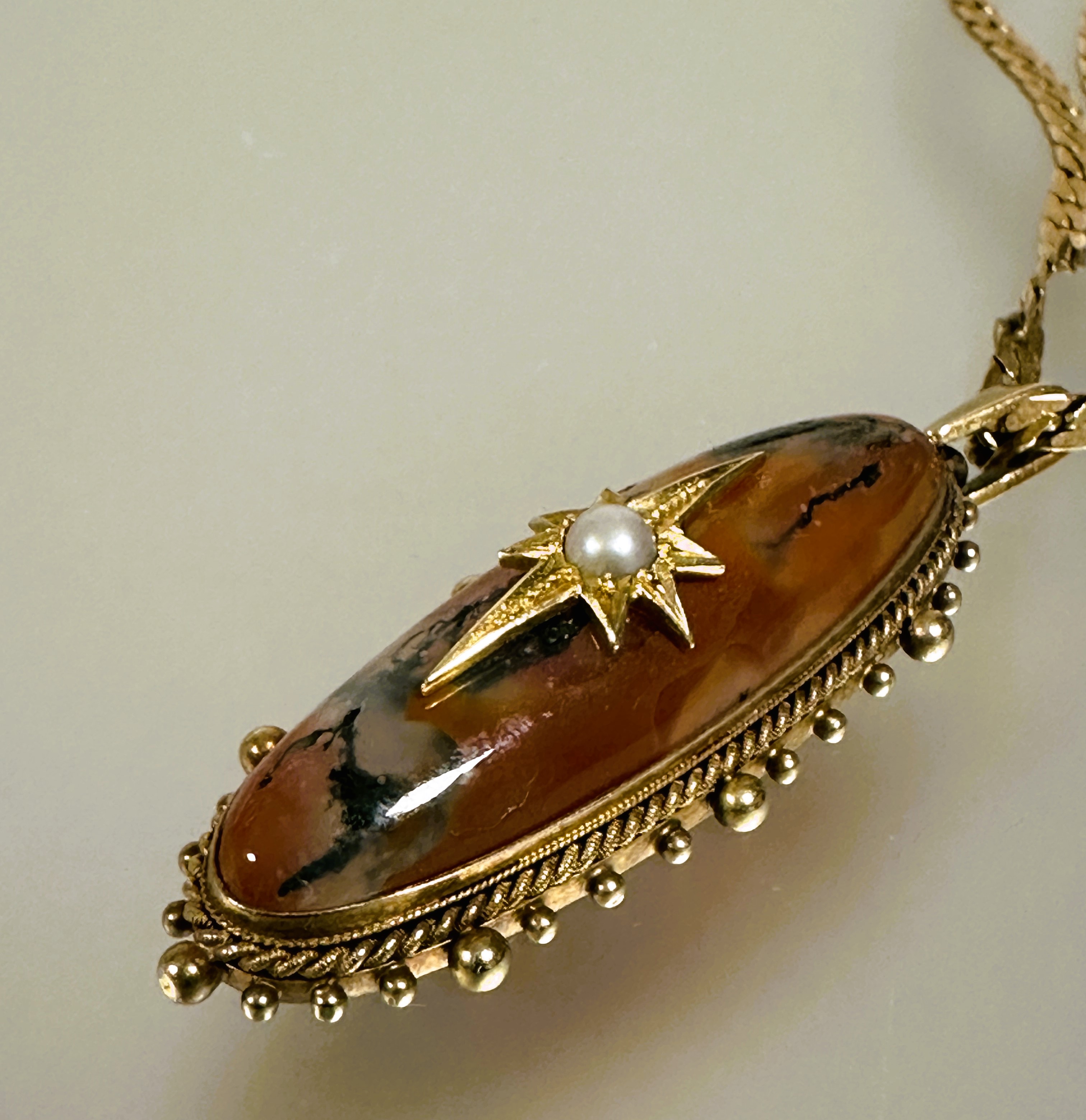 A Victorian yellow metal navette shaped pendant set moss age with star set center half seed pearl - Image 2 of 3