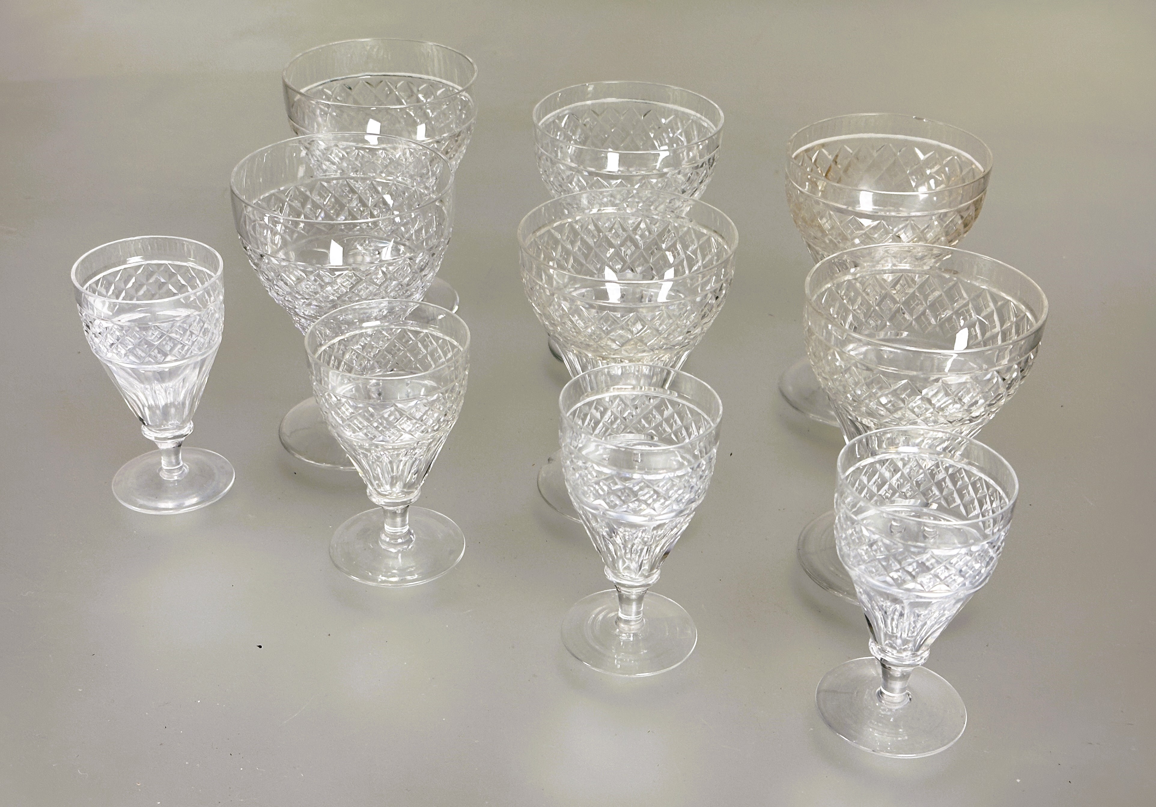 A part set of crystal slice cut tapered glasses to include a pair of red wine glasses, H x 11.5cm,