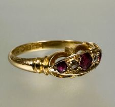 A 18ct gold three stony ruby ring the center cut stone 0.15ct flanked by a rose cut diamond and