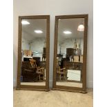 A pair of traditional wall hanging mirrors in carved oak frames. 171cm x 81cm.