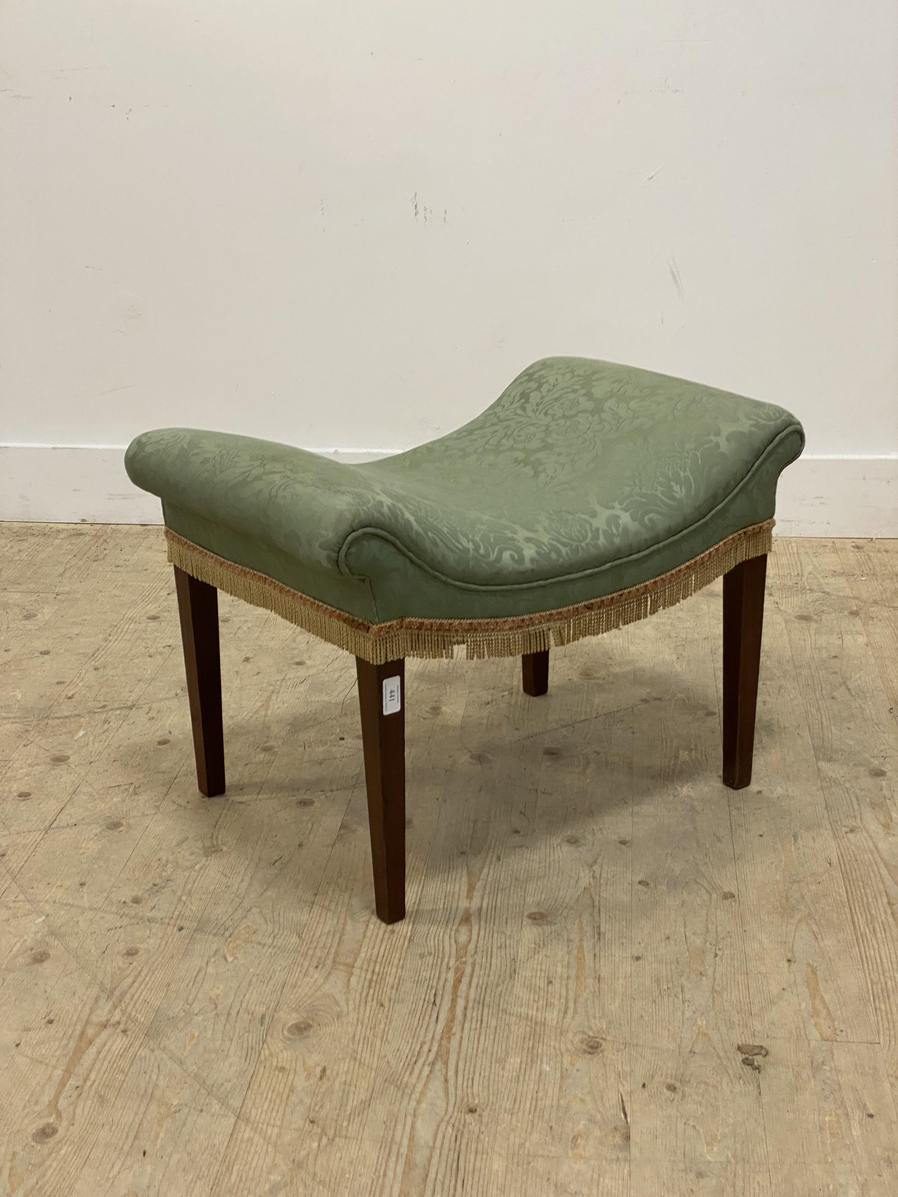 An early 20th century stool, the dished top upholstered in green damask, raised on square tapered