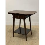 An Arts and Crafts period mahogany side table, the shaped top above a drawer and raised on square