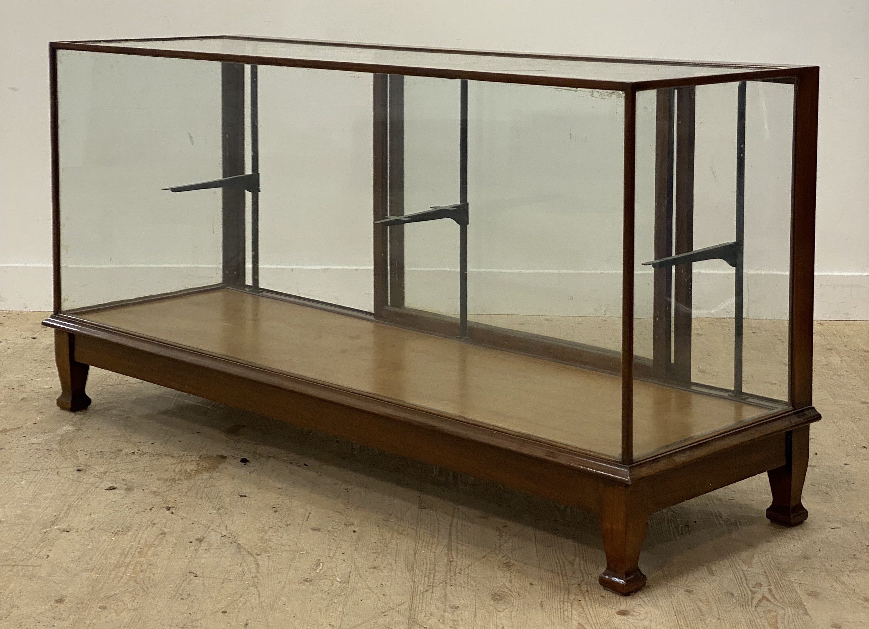 An early 20th century walnut framed shops / haberdashers counter, glazed all round and with