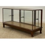 An early 20th century walnut framed shops / haberdashers counter, glazed all round and with