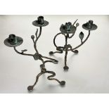 A pair of cast bronze scrolling stem floral two branch candelabra raised on tripartite base with pad