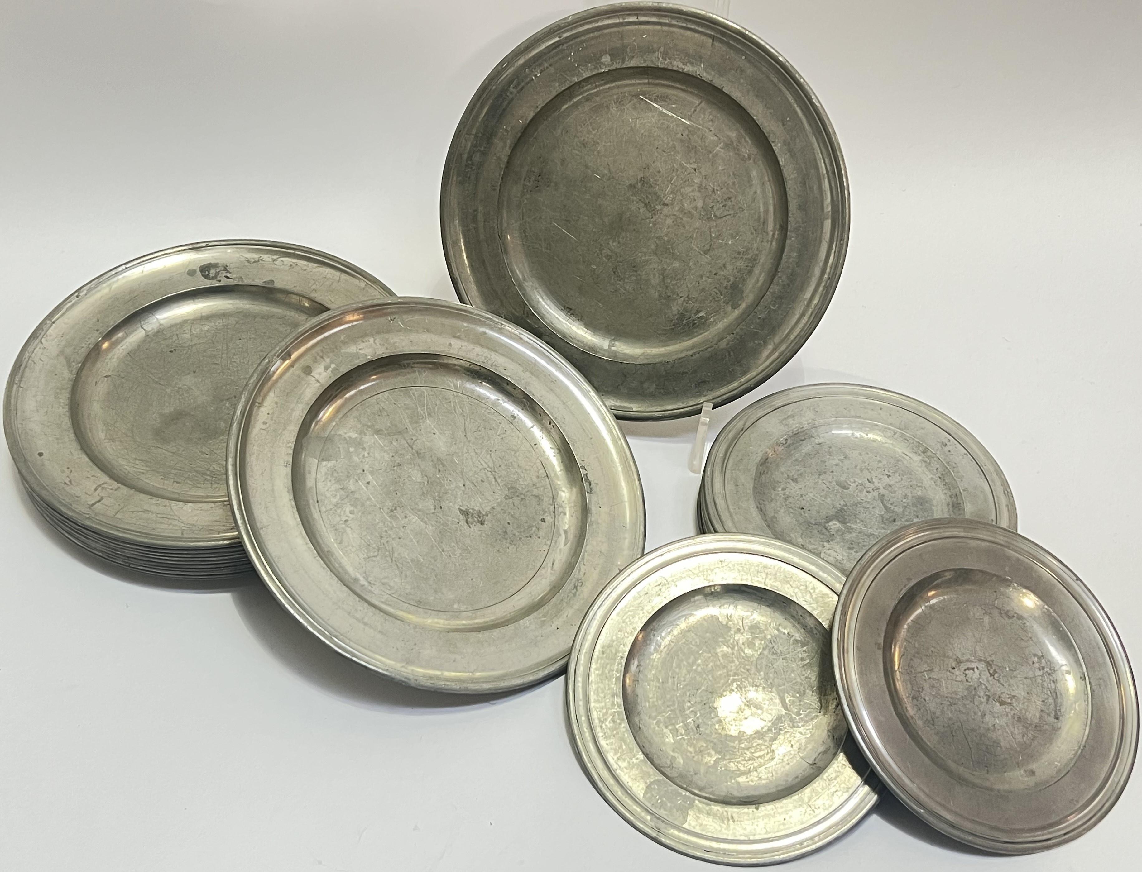 A group of twelve pewter plates (w- 24cm), marked Brasil verso, together with another twelve