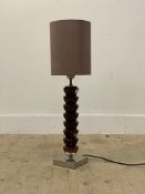 A contemporary table lamp, the acrylic column on a chrome base, complete with shade. H71cm.