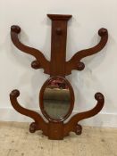 A Victorian mahogany wall mounted hat and coat stand with twin scrolling arms to each side and