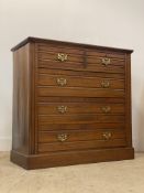 An Edwardian walnut chest, fitted with two short and three long drawers, raised on a plinth base.