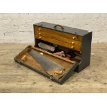 A gray painted joiners tool box with collection of woodworking tools. H42cm, L77cm.