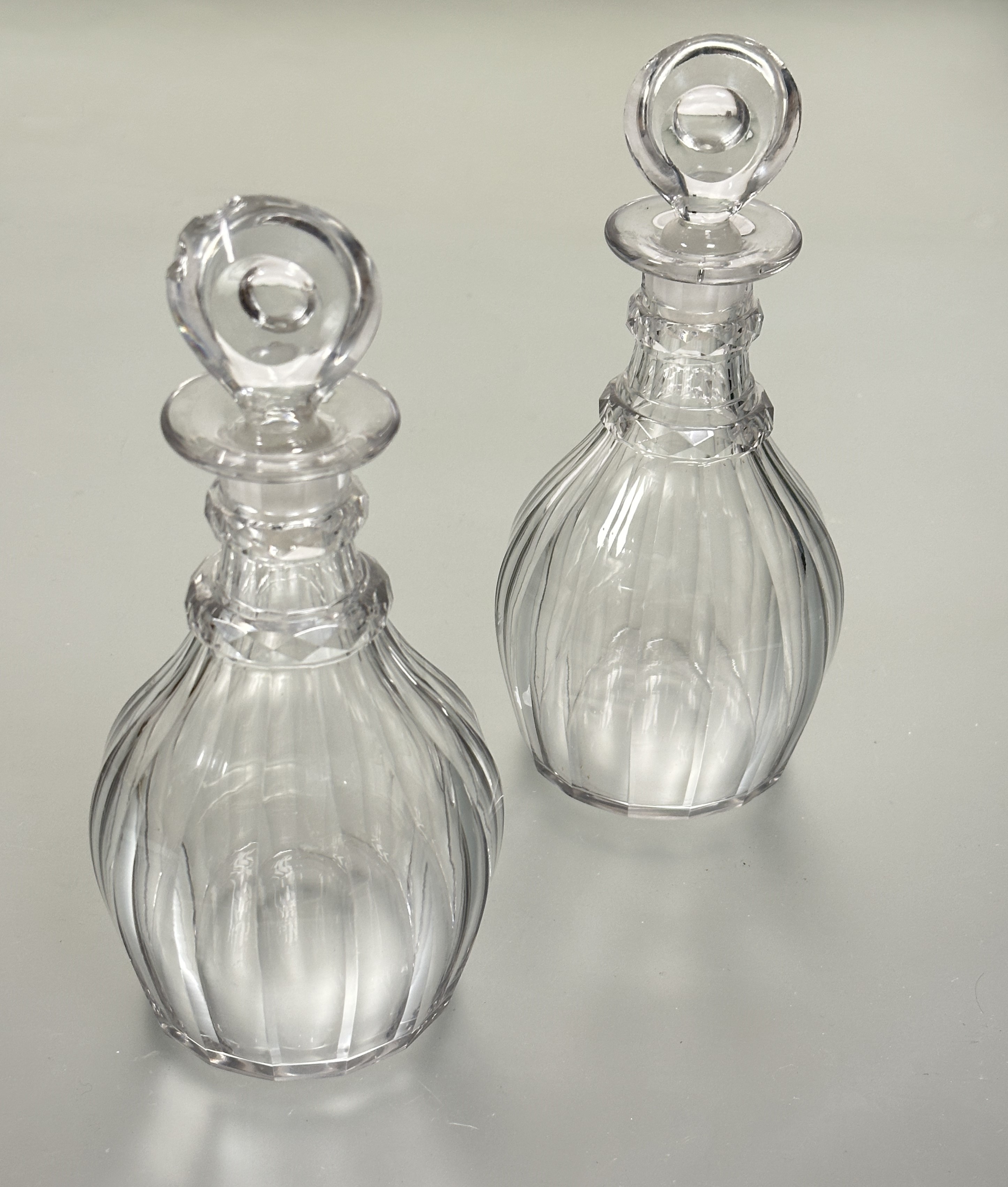 A pair of Georgian mallet shaped fluted crystal decanters with original stoppers chips to edge of