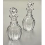 A pair of Georgian mallet shaped fluted crystal decanters with original stoppers chips to edge of
