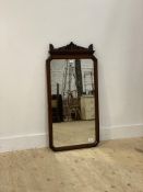 An Edwardian mahogany framed mirror with pierce carved surmount. 110cm x 54cm.