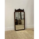 An Edwardian mahogany framed mirror with pierce carved surmount. 110cm x 54cm.