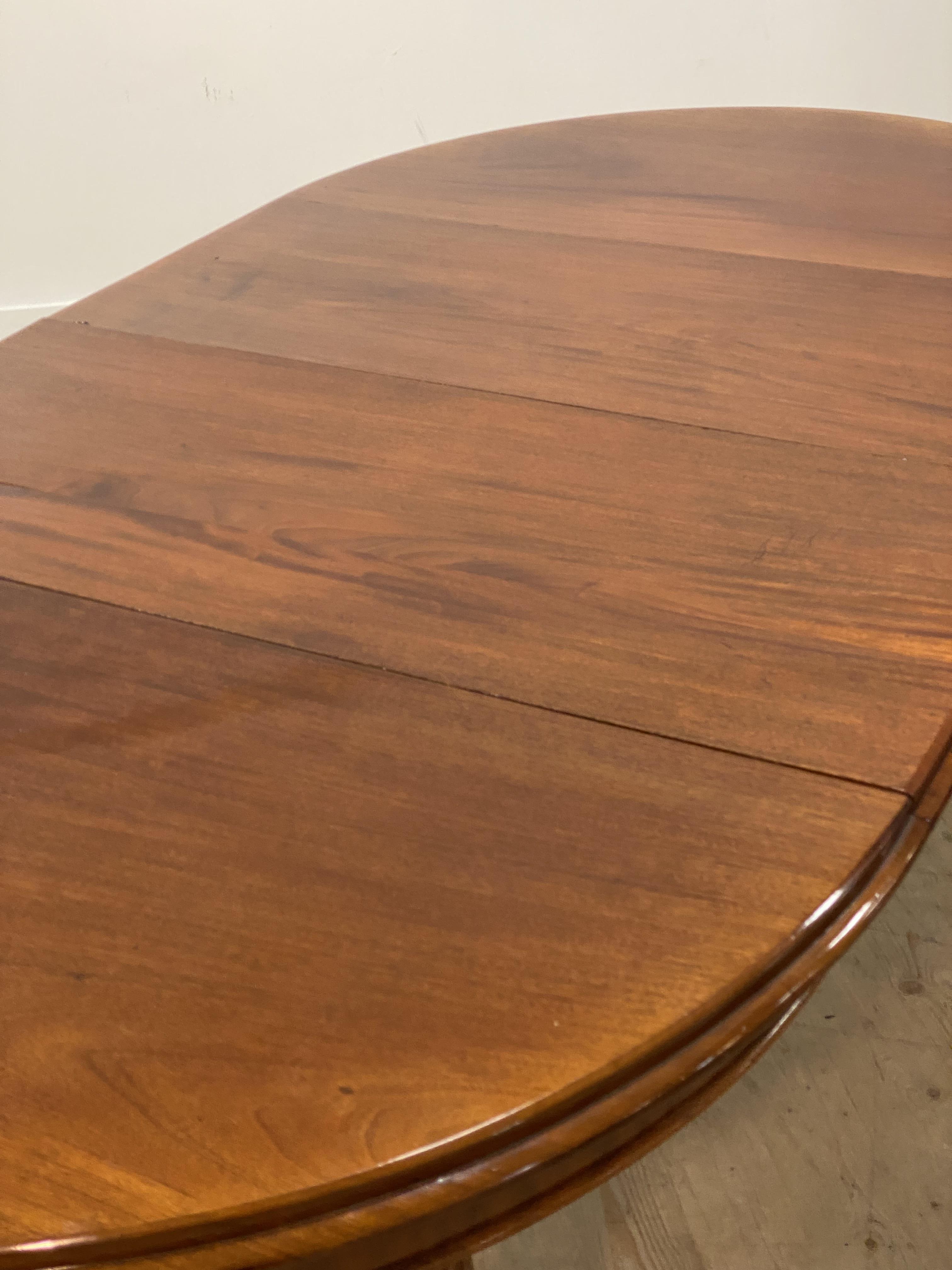A Victorian mahogany wind out extending dining table, the oval top with two leaves, raised on turned - Image 2 of 4