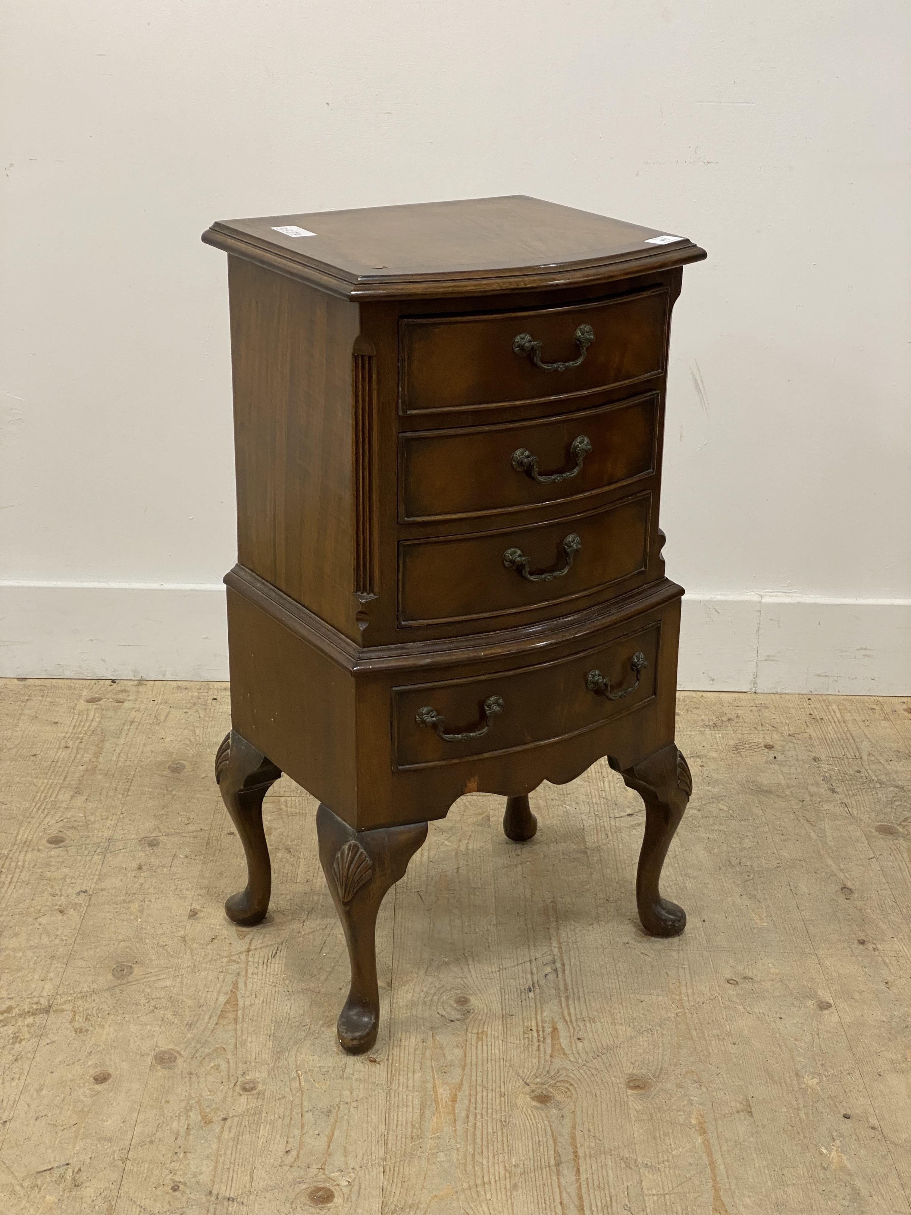 A Georgian style mahogany bow front chest, fitted with four drawers and raised on shell carved