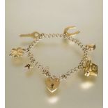 A 9ct gold kerblink bracelet with heart shaped padlock and safety chain and six various charms to