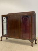 A Georgian style mahogany bow front display cabinet, the raised back above a gadrooned edge, with