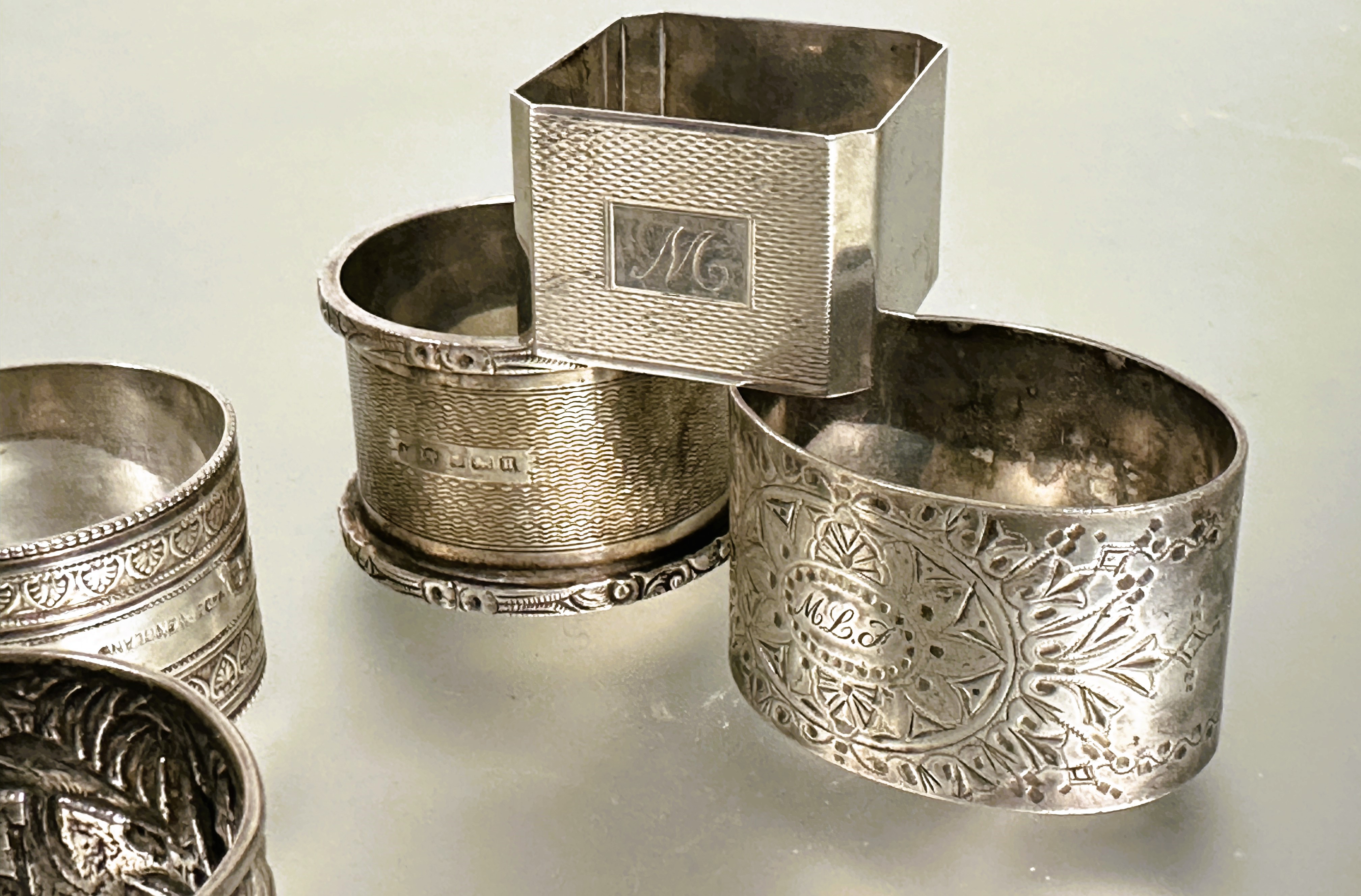 A collection of napkin rings to include a Birmingham silver with engine turned decoration and cast - Image 3 of 3