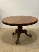 A Victorian mahogany tilt top breakfast table, the circular top raised on three acanthus leaf carved