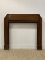 An Art Deco period walnut fire surround, aperture 100cm x 100cm. (H132cm, W135cm.)