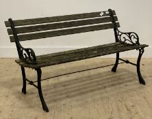 A traditional slatted teak and cast iron garden bench. L125cm.