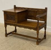 An oak hall bench, the cupboard with flanked by a seat with open arm and linen fold carved panel