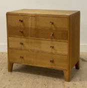 A mid century dry oak chest of two short and three long graduated drawers, raised on tapered stile