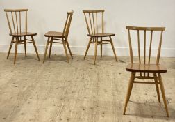 Ercol, a set of four beech and elm comb back dining chairs, each with gold label verso. H80cm.