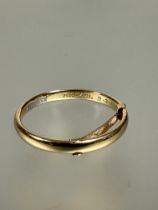 A 18ct gold wedding band with engraved inscription, Michael 9.3.1963 with 9ct sized adjustment