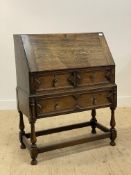 Jas Shoolbred, an early 20th century oak bureau, the fall front opening to a fitted interior,