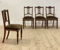 A set of four Victorian walnut dining chairs, each with floral carved crest rail above urn splat,