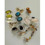 A collection of eight pairs of earrings to include a pair of silver oval faceted yellow stone