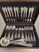 A oak canteen containing a suite of Continental white metal plated flatware to include, eleven