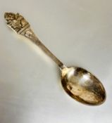A Danish 830 standard white metal spoon by Orla Vagn Mogensen with figures by a well and buts of