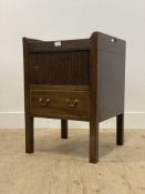 A Georgian mahogany wash stand, the tray top with pierced carry handles above a tambour door and