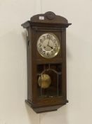 An early 20th century oak cased Vienna type wall clock, with silvered dial and Arabic chapter