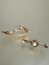 An Edwardian yellow metal wishbone style brooch set three water opal cabochons, each stone