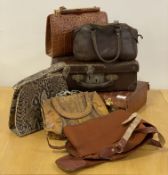 A group of six vintage leather / snakeskin / alligator skin hand bags and brief cases, and a gun
