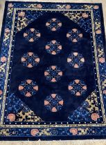 A Chinese super washed wool carpet, the blue ground decorated with repeating medallions and having a