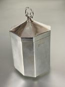 A Edwardian Birmingham silver octagonal panel sided and domed top tea caddy with scrolling loop
