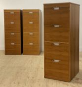 A set of three contemporary walnut veneered four drawer hanging filling cabinets. H134cm, W49cm,