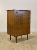 A mid century teak chest fitted with five drawers and raised on square tapered supports. H107cm,