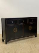 A Chinese style black painted hall sideboard, fitted with three drawers above four cupboard doors,