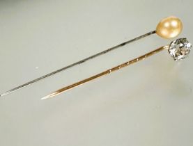 A 9ct gold stick pin set faceted clear stone L x 5cm 1.00g and a white metal stick pin set paste