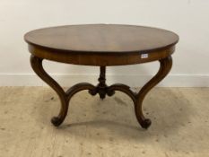 A Victorian oak centre table, the circular top raised on three scrolled supports united by