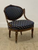 A French walnut upholstered bedroom chair, circa 1900, with a floral carved show frame and raised on