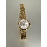 A 18ct gold Vewe ladys wrist watch with silvered satin dial and arabic numerals at 12 and 6 on